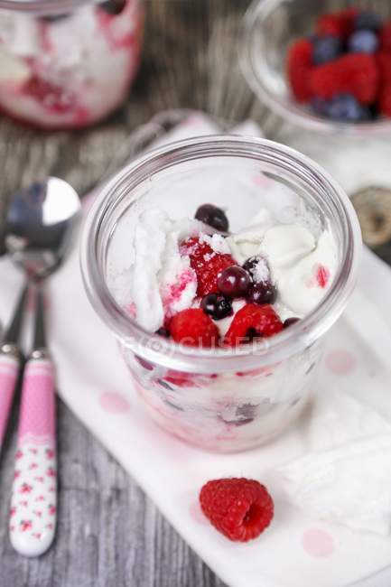 Closeup view of Pavlova with berries in a glass jar — Stock Photo
