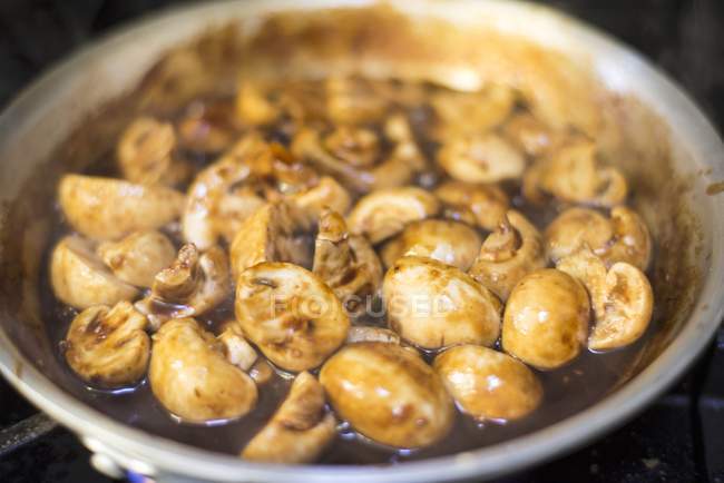 Closeup view of braised mushrooms in a frying pan — Stock Photo