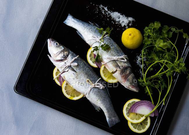 Branzino fish stuffed with herbs — Stock Photo