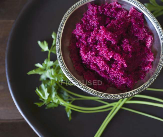 Beetroot and  horseradish in a silver bowl over black plate — Stock Photo