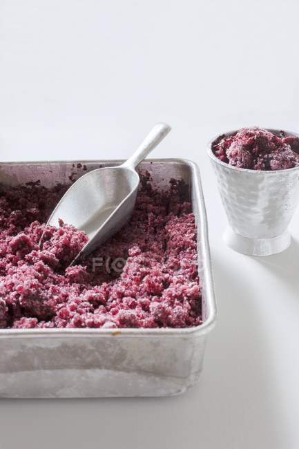 Closeup view of blueberry Granita in a metal tin and a metal cup — Stock Photo