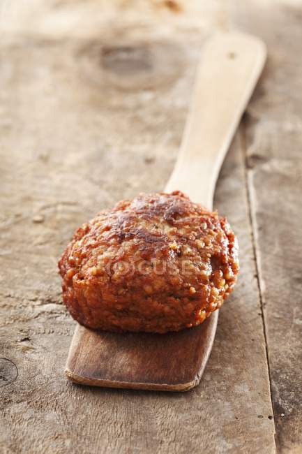 Meatball on wooden spoon — Stock Photo