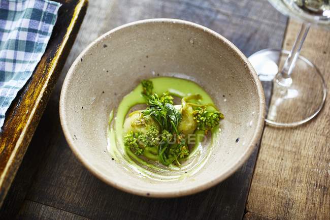 Closeup view of kohlrabi with rape flowers and cucumber mayonnaise — Stock Photo