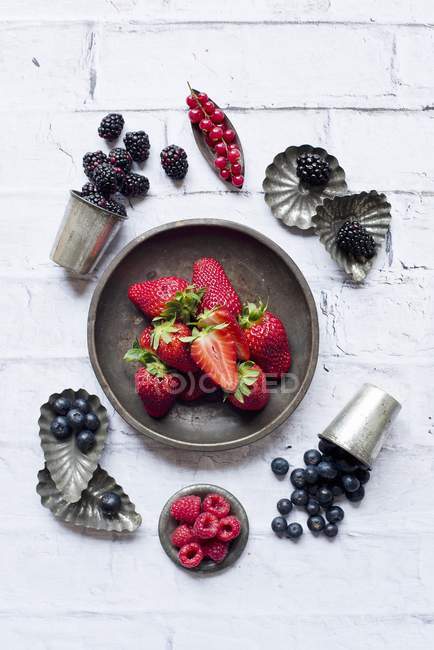 Fresh ripe berries with baking tins — Stock Photo