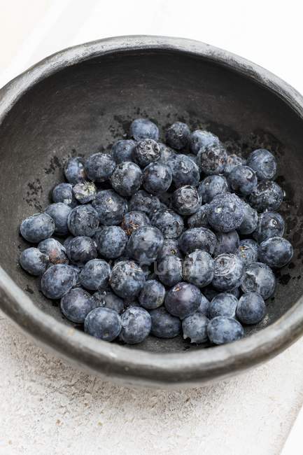 Blueberries in old bowl — Stock Photo