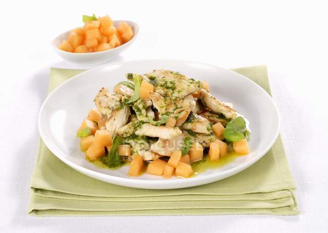Roasted Herb-coated chicken with melon — Stock Photo
