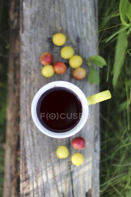 Tasse Kaffee und Mirabellen-Pflaumen — Stockfoto