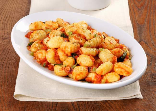 Gnocchi pasta with tomato sauce and herbs — Stock Photo