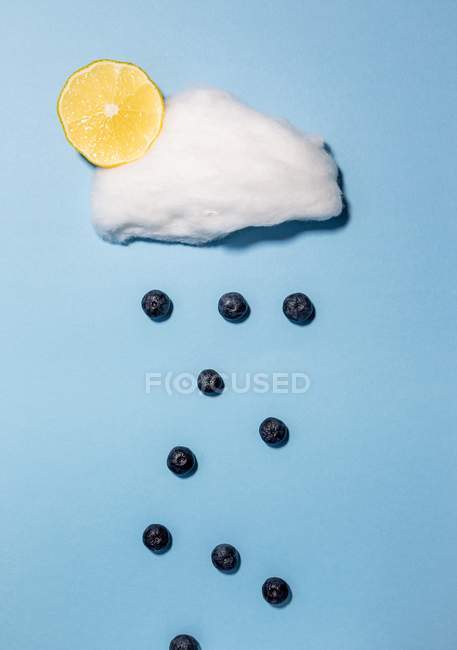 Closeup view of blueberries falling from a candyfloss cloud — Stock Photo
