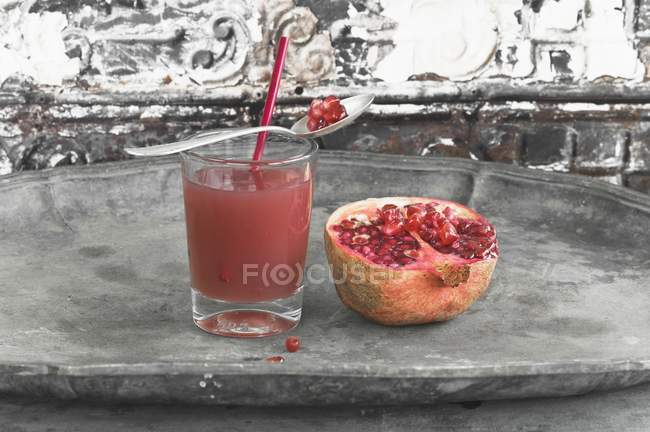 Pomegranate juice in glass — Stock Photo