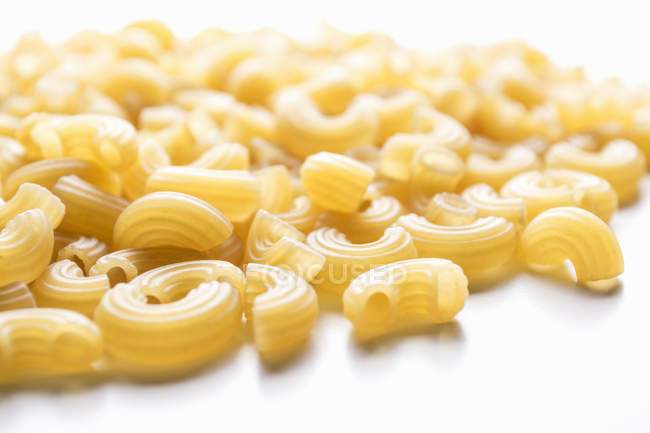 Dry uncooked elbow macaroni pasta — Stock Photo