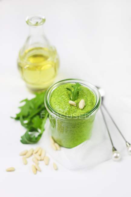 Closeup view of rocket sauce with pine nuts — Stock Photo