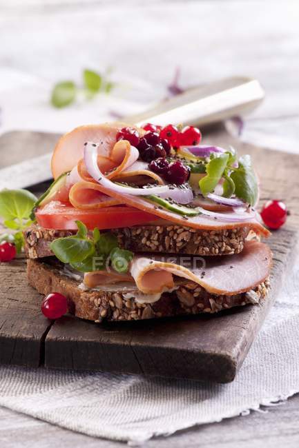 Slice of bread topped with ham — Stock Photo