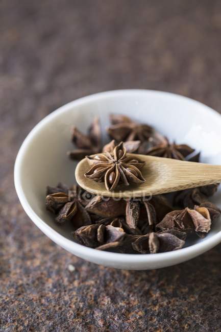 Star anise with a wooden spoon — Stock Photo