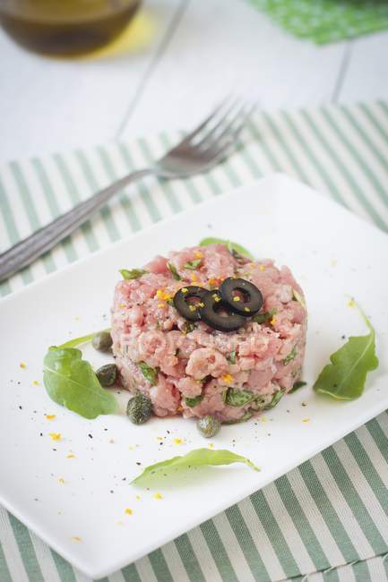 Tartare with olives and capers — Stock Photo
