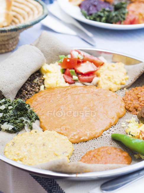Ethiopian fasting food on platter over tablecloth — Stock Photo