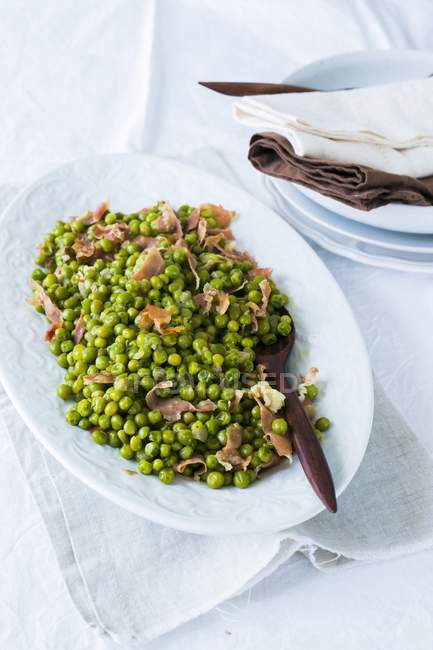 Peas with chopped Prosciutto — Stock Photo