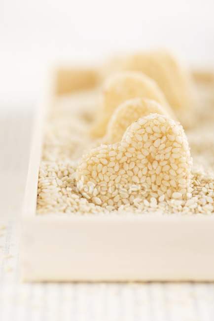 Closeup view of homemade heart-shaped sesame seed sweets — Stock Photo