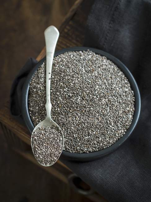 Chia seeds in dish with spoon — Stock Photo