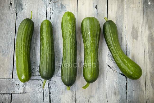 Mini cucumbers on a wooden surface — Stock Photo