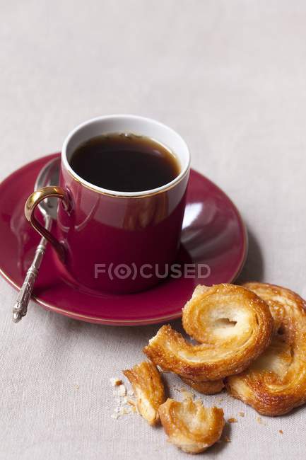 Baked palmiers and cup of coffee — Stock Photo
