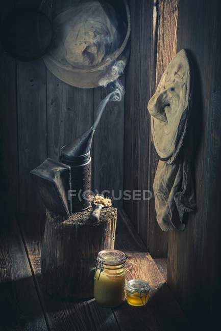 Honey and old beekeeper tools — Stock Photo