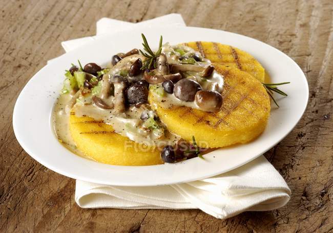 Closeup view of grilled Polenta with mushrooms and rosemary — Stock Photo