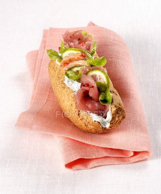 Rye bread roll with salmon — Stock Photo