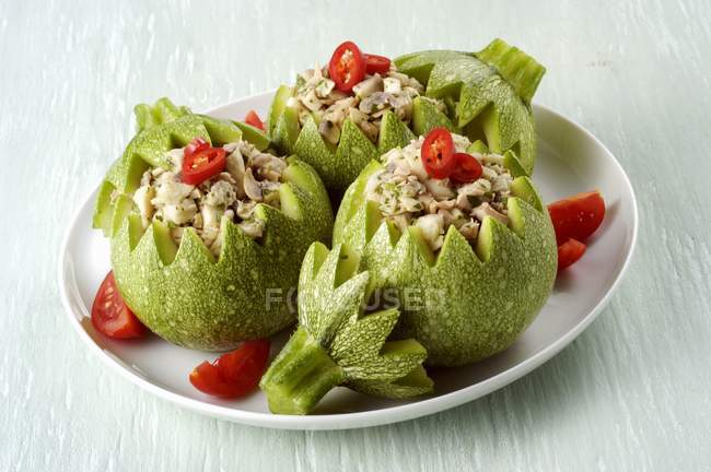 Round courgettes stuffed with mushrooms on white plate — Stock Photo