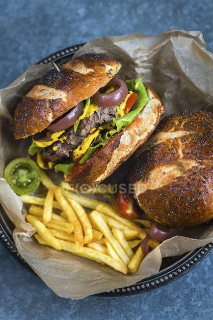 Burgers in pretzel buns — Stock Photo