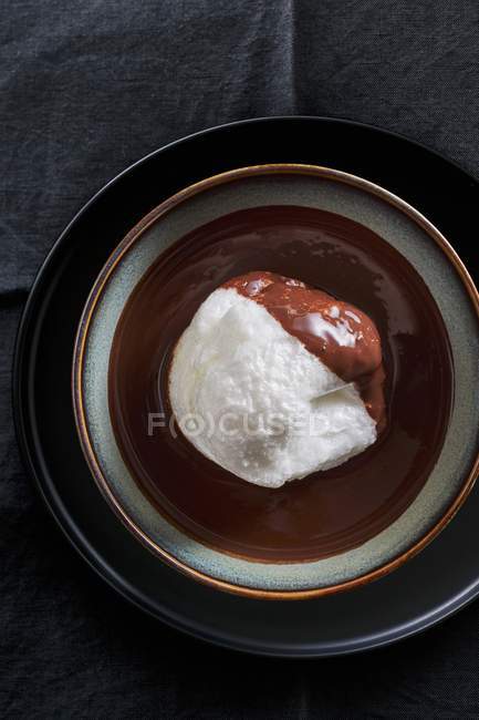 Closeup top view of floating island in chocolate sauce — Stock Photo