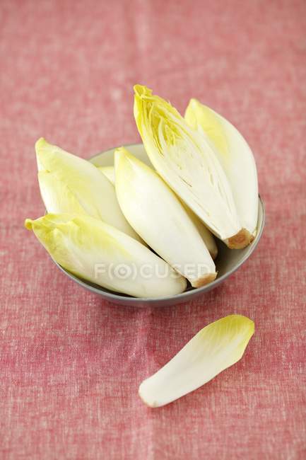 Chicory in a bowl and on table — Stock Photo