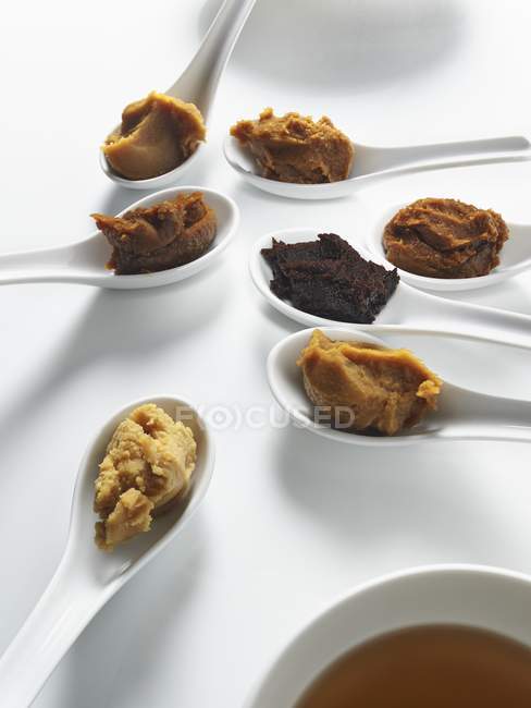 Elevated view of spoons with different Miso pastes — Stock Photo