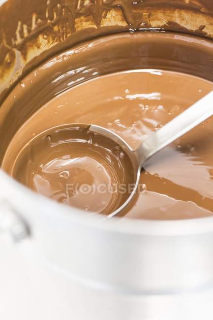 Chocolate sauce in saucepan with ladle — Stock Photo