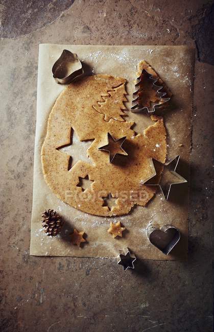Top view of cinnamon dough with Christmas cookie cutters — Stock Photo