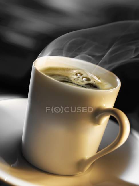 Steaming cup of black coffee — Stock Photo