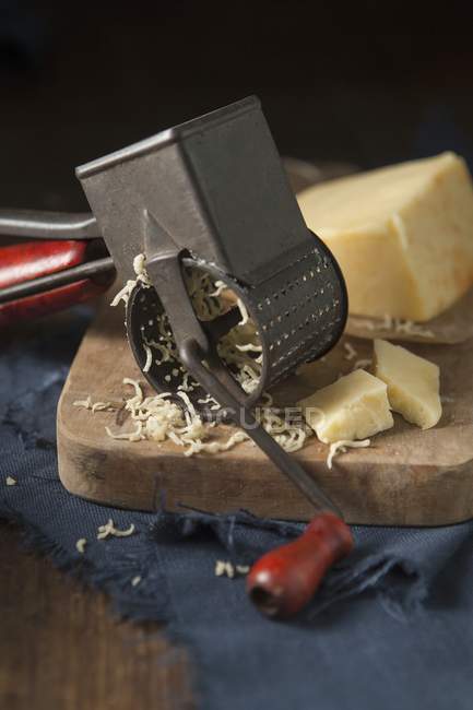 Cheddar cheese and grater — Stock Photo