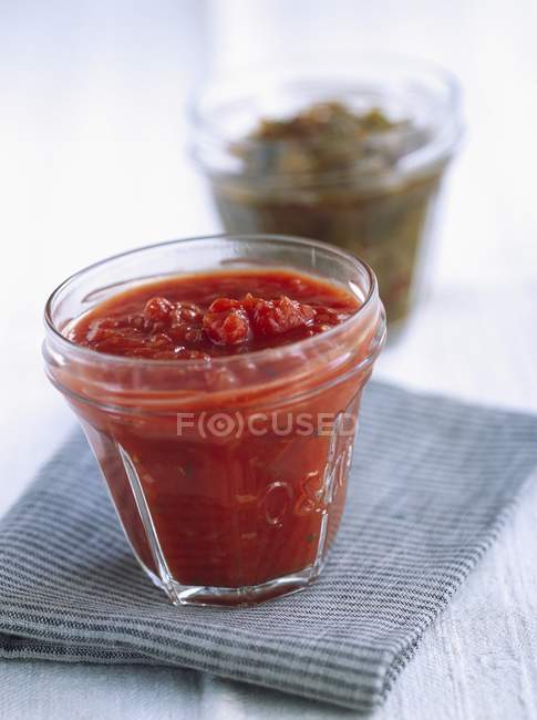 Ketchup in a glass pot — Stock Photo