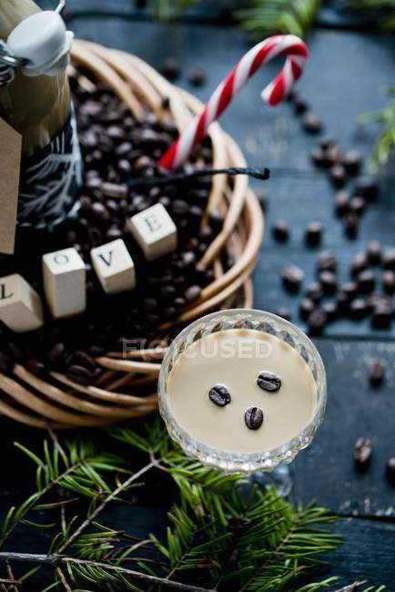 Vista ravvicinata del liquore al caffè in vetro con chicchi di caffè e decorazioni — Foto stock