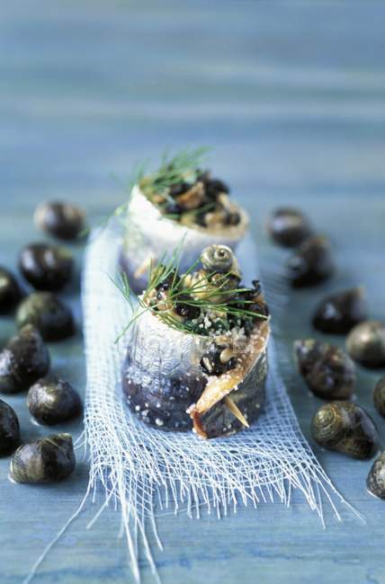 Sardine rolls with snails — Stock Photo