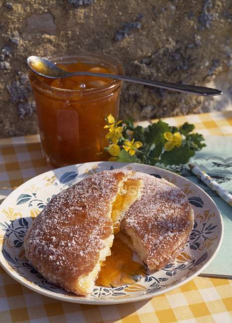 Closeup  daytime view of apricot jam and bun halves — Stock Photo
