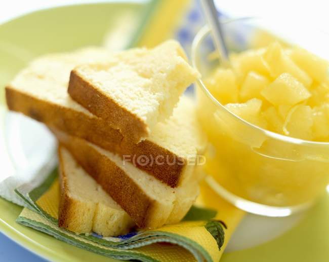 Slices of cake and diced fruit — Stock Photo