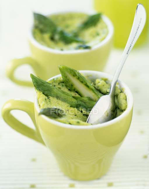 Individual green asparagus Flans in green cups with spoon — Stock Photo