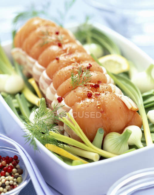 Roast salmon with bacon and vegetables — Stock Photo