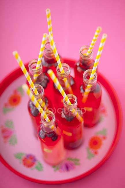 Raspberry lemonade in small bottles — Stock Photo