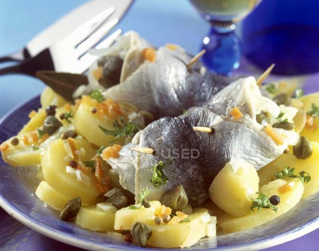 Rollmops on plate over table — Stock Photo