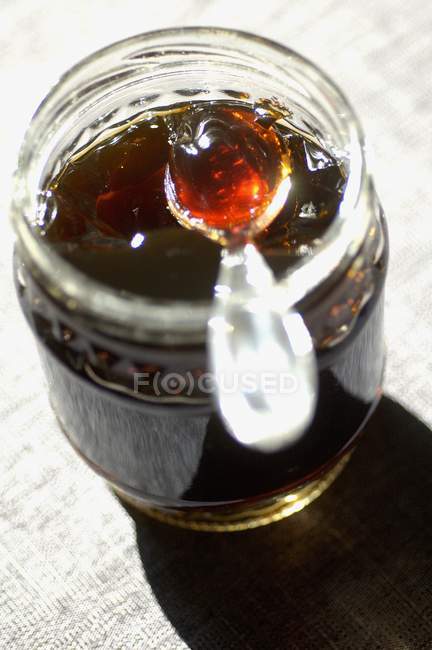 Coffee jam in jar with spoon — Stock Photo