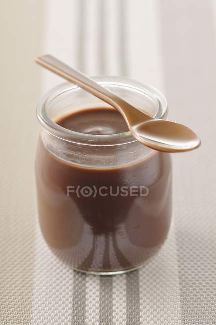 Chocolate yogurt in glass jar — Stock Photo