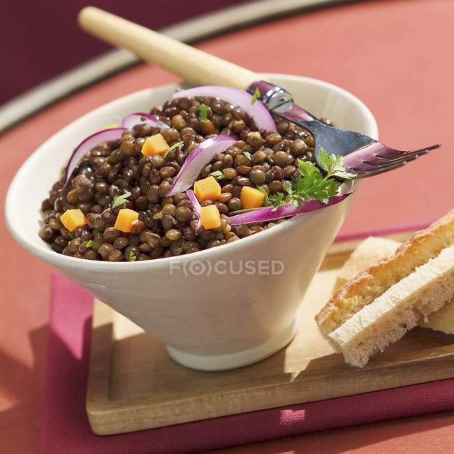 Warm lentil salad in bowl — Stock Photo