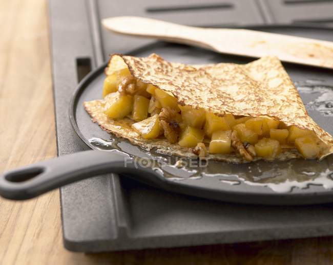 Pancake with apples on pan — Stock Photo